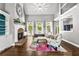 Open living space with fireplace, large windows and a view to the kitchen at 4251 Lantern Hill Dr, Dacula, GA 30019