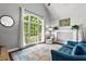 Bright living room featuring a large window, comfortable seating, and modern decor at 4251 Lantern Hill Dr, Dacula, GA 30019