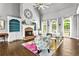 Bright living room featuring a fireplace, built-in shelving, and hardwood floors at 4251 Lantern Hill Dr, Dacula, GA 30019