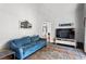 Comfortable living room with a blue sofa, area rug, and television at 4251 Lantern Hill Dr, Dacula, GA 30019
