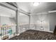 Open loft area featuring neutral walls, carpet, and a wrought iron railing overlooking the floor below at 4251 Lantern Hill Dr, Dacula, GA 30019