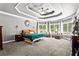 Spacious main bedroom featuring a decorative tray ceiling, sitting area, and large windows at 4251 Lantern Hill Dr, Dacula, GA 30019