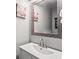 Stylish powder room with modern vanity, decorative mirror, and whimsical pig art at 4251 Lantern Hill Dr, Dacula, GA 30019