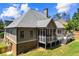 Stunning rear exterior features a spacious deck and screened porch, perfect for outdoor entertaining at 4251 Lantern Hill Dr, Dacula, GA 30019