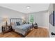 Comfortable bedroom featuring hardwood floors, soft natural light, and a stylish metal bedframe at 786 Neal Nw St, Atlanta, GA 30318
