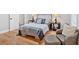 Bedroom showcasing hardwood floors and stylish furnishings, including a cozy chair and ottoman at 786 Neal Nw St, Atlanta, GA 30318