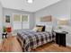Bright bedroom with hardwood floors, natural light, and a comfortable bed with patterned pillows at 786 Neal Nw St, Atlanta, GA 30318