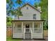 Charming two-story home featuring a welcoming front porch, freshly painted siding, and a well-maintained yard at 786 Neal Nw St, Atlanta, GA 30318