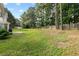 Expansive backyard featuring a well-maintained lawn, patio, mature trees and privacy fence at 9307 Glenleigh Way, Jonesboro, GA 30236
