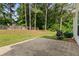 Fenced backyard with a patio, grill, lawn, and wooded area, perfect for outdoor entertaining at 9307 Glenleigh Way, Jonesboro, GA 30236