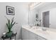 Bathroom featuring a double sink vanity, a large mirror and a decorative plant for an airy feel at 9307 Glenleigh Way, Jonesboro, GA 30236