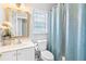 Bathroom with white vanity and a blue patterned shower curtain at 9307 Glenleigh Way, Jonesboro, GA 30236