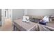 Bright bedroom featuring neutral walls and tables with sewing machines, creating a versatile space at 9307 Glenleigh Way, Jonesboro, GA 30236