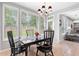 Dining area with natural light from windows, table and chairs viewable, and view into living area at 9307 Glenleigh Way, Jonesboro, GA 30236