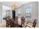Elegant dining room with a classic chandelier and backyard views at 9307 Glenleigh Way, Jonesboro, GA 30236