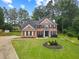 Beautiful two-story brick home with a well-manicured lawn and ample greenery at 9307 Glenleigh Way, Jonesboro, GA 30236