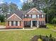 Charming two-story brick home with lush lawn and manicured landscaping at 9307 Glenleigh Way, Jonesboro, GA 30236