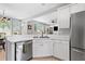 Kitchen area with white cabinets, stainless steel appliances, and bar seating at 9307 Glenleigh Way, Jonesboro, GA 30236