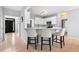 An open concept kitchen featuring white cabinets, a breakfast bar and stainless steel appliances at 9307 Glenleigh Way, Jonesboro, GA 30236