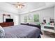 Bright main bedroom featuring a tray ceiling, a ceiling fan and large windows for an airy feel at 9307 Glenleigh Way, Jonesboro, GA 30236