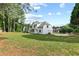 Expansive backyard with a two-story home featuring a well-maintained lawn and mature trees at 9307 Glenleigh Way, Jonesboro, GA 30236