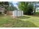 A metal outdoor storage shed in a backyard at 9307 Glenleigh Way, Jonesboro, GA 30236