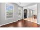 Sun-lit sitting room with hardwood floors and views to the dining room and foyer at 9307 Glenleigh Way, Jonesboro, GA 30236