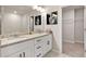 Bathroom with granite countertops, double sinks, walk-in closet, and decorative wall art at 181 Dewy Rd # 70, Lilburn, GA 30047