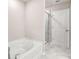 Bathroom featuring a soaking tub with glass shower, and tile floors at 181 Dewy Rd # 70, Lilburn, GA 30047