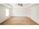 Spacious bedroom with plush carpet, a ceiling fan, and tray ceilings at 181 Dewy Rd # 70, Lilburn, GA 30047