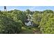 Overhead shot of a charming property surrounded by mature trees and greenery at 2 N Broad St, Porterdale, GA 30070