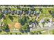 Bird's eye view featuring residences, a baseball field, and surrounding foliage at 2 N Broad St, Porterdale, GA 30070