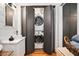 Bathroom featuring a convenient stackable washer and dryer hidden behind folding doors at 2 N Broad St, Porterdale, GA 30070