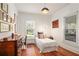 Bright bedroom with hardwood floors, natural light, and tasteful decor at 2 N Broad St, Porterdale, GA 30070