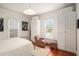 Bright bedroom with white walls, hardwood floors, large windows, and closet space at 2 N Broad St, Porterdale, GA 30070