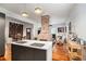 Open-concept living space with a brick fireplace, views to the kitchen, and a dining area at 2 N Broad St, Porterdale, GA 30070