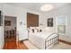 Cozy main bedroom with white walls, hardwood floors, and stylish decor at 2 N Broad St, Porterdale, GA 30070