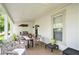 Charming covered porch with an outdoor dining area and grill at 2 N Broad St, Porterdale, GA 30070