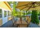 Outdoor patio with table and chairs, large umbrella, and lush green surroundings at 2366 Battle Forest Sw Dr, Marietta, GA 30064