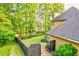 Aerial view of the backyard with a fenced yard, mature trees, and view of the neighborhood pond at 2366 Battle Forest Sw Dr, Marietta, GA 30064