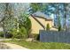 Image of backyard with lawn, garden and privacy fence with mature trees in background at 2366 Battle Forest Sw Dr, Marietta, GA 30064