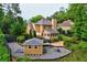 Backyard featuring a deck, enclosed porch, outbuilding and gravel patio area at 2366 Battle Forest Sw Dr, Marietta, GA 30064