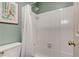 Bright bathroom featuring a tub with white tile surround and a shower head at 2366 Battle Forest Sw Dr, Marietta, GA 30064