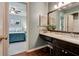 Bathroom vanity with dark wood cabinets, granite countertops, sink, and view to the bedroom at 2366 Battle Forest Sw Dr, Marietta, GA 30064