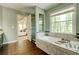 This bathroom features a soaking tub with jets, a tile surround, and a large window at 2366 Battle Forest Sw Dr, Marietta, GA 30064