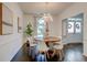 Bright dining room boasts modern chandelier, hardwood floors, and natural light at 2366 Battle Forest Sw Dr, Marietta, GA 30064