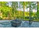 Backyard firepit area with seating, decorative gravel, and mature trees at 2366 Battle Forest Sw Dr, Marietta, GA 30064
