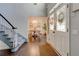 Bright foyer with hardwood floors, staircase, and double doors, leading to dining area at 2366 Battle Forest Sw Dr, Marietta, GA 30064