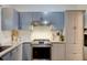 This kitchen has stainless steel appliances, light gray cabinets, and granite countertops at 2366 Battle Forest Sw Dr, Marietta, GA 30064