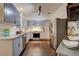 Well-lit kitchen with gray cabinets, granite countertops, stainless steel appliances, and hardwood floors at 2366 Battle Forest Sw Dr, Marietta, GA 30064